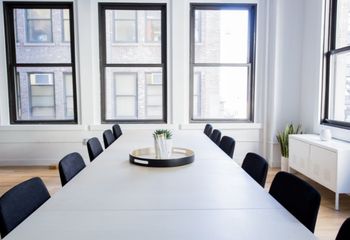 Modern office meeting room with a conference table.